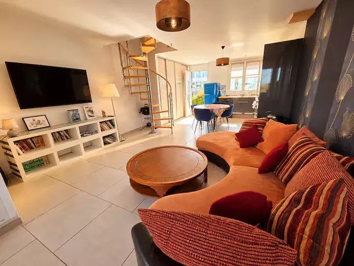 Lounge with curved sofa and spiral staircase