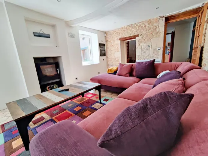 Lounge with stone wall and pink sofa